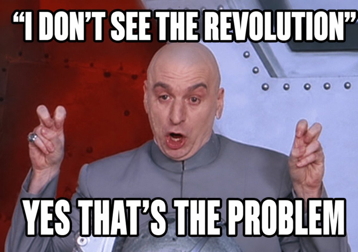 A bald man in a grey suit gestures while expressing disbelief about a revolution, with a dramatic background and text emphasizing his words.